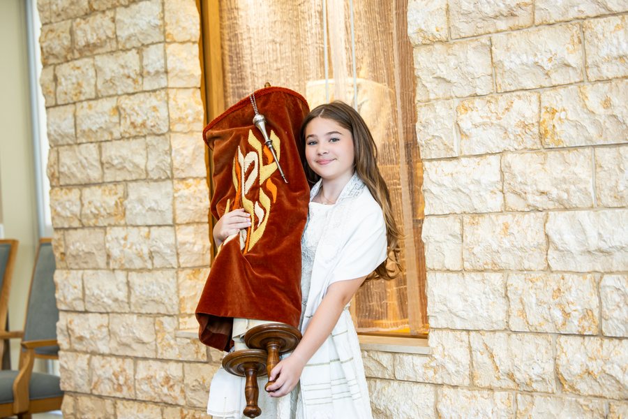 Allison holding the Torah at the synagogue on her Bat Mitzvah day